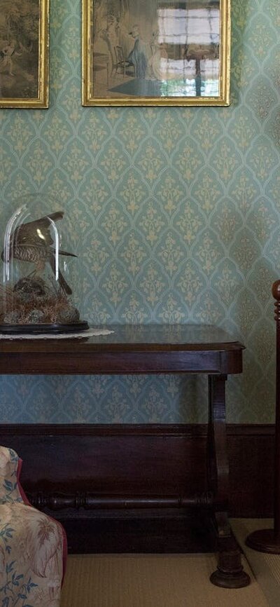 image of a mother and two children looking at furniture inside lanyon homestead