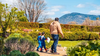 An adult and two children explore the gardens at Lanyon Homestead