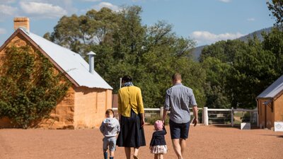 family walking in Lanyon courtyard surrounded by heritage buildings