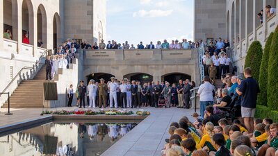 A large group of people attending the Last Post Ceremony at the Australian War Memorial