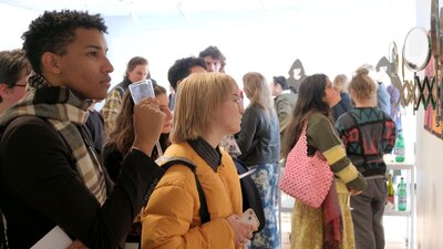 Visitors admiring work at Richard Harding's exhibition 'Moving in Circles' at Megalo