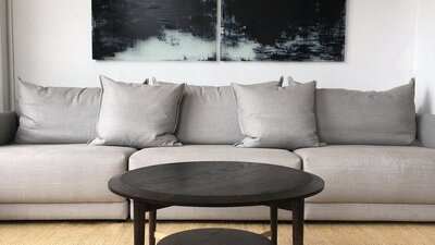 Grey sofa on a jute rug, with walnut coffee table.