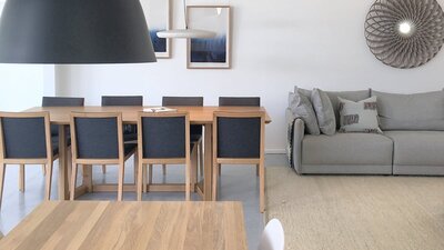 Showroom photo featuring dining tables and pendants.