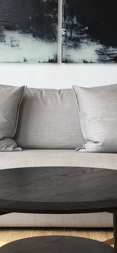 Grey sofa on a jute rug, with walnut coffee table.