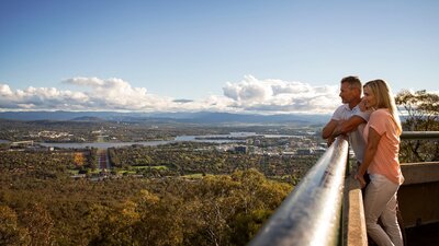 Couple looking out over Canberra from the lookout