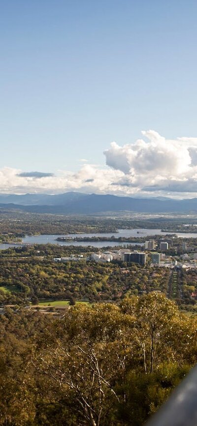 Marvel at the views over a planned capital Couple looking out over Canberra from the lookout