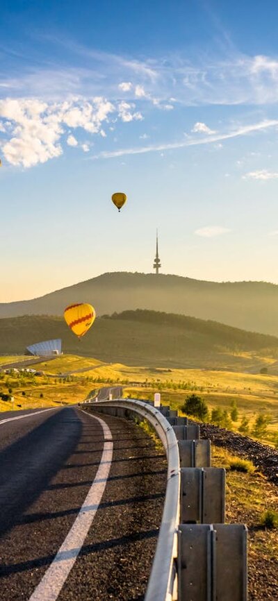 road framed by balloons on horizon