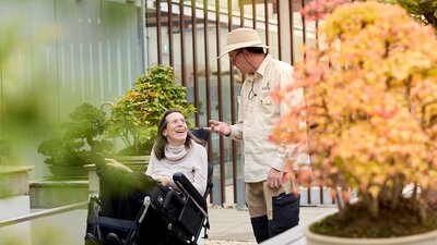 Volunteer guide talking with visitor in a wheelchair