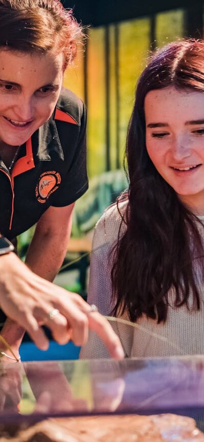 Tour Director, Nicole, points to a plague with teenage girl