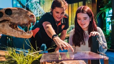 Tour Director, Nicole, points to a plague with teenage girl