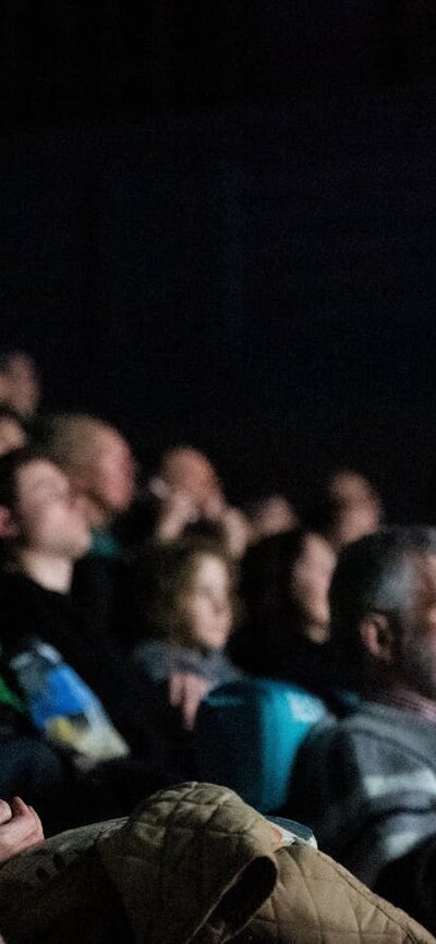 A group of people in a cinema (screen is not visible)