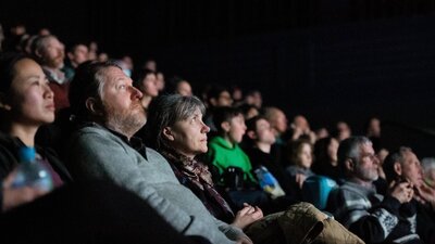 A group of people in a cinema (screen is not visible)