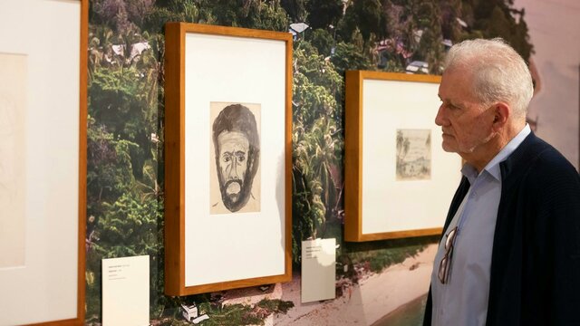 Treasures Gallery at the National Library of Australia A gentleman viewing a collection piece in a gallery