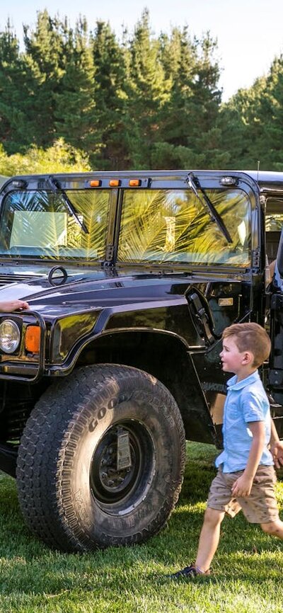 Family and zoo guide with a Hummer, a vehicle used for night tours within the national zoo