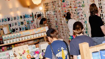 Shoppers exploring a vibrant selection of locally made goods, candles, keychains, and more.