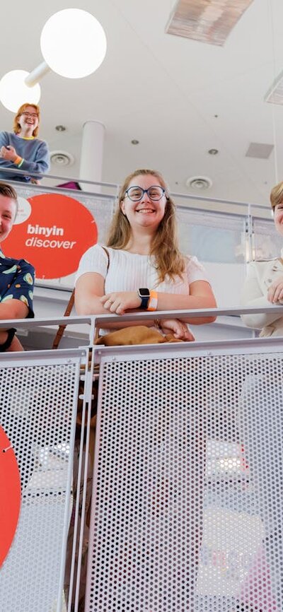 6 young people stand on the Questacon ramp looking down at the photographer