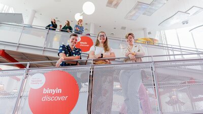 6 young people stand on the Questacon ramp looking down at the photographer