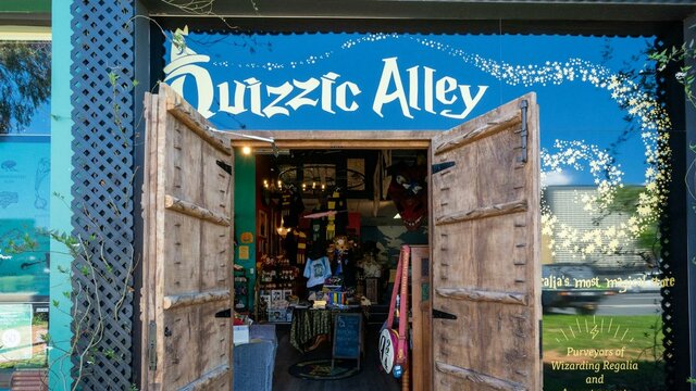 Witches, wizards, magical creatures and Muggles all welcome! Quizzic Alley's entrance, flanked by impressive timber castle doors.