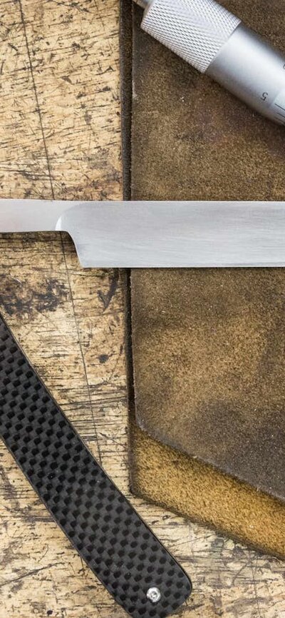 traditional straight razor on a workbench