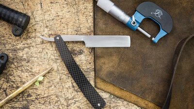 traditional straight razor on a workbench