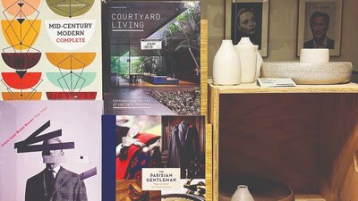 Art and fashion book covers next to ceramic bowls and vessels