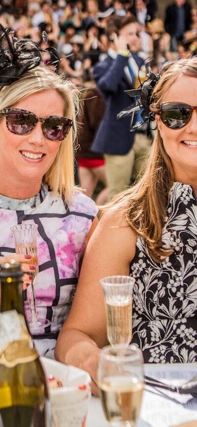 Ladies dressed for the races enjoying champagne