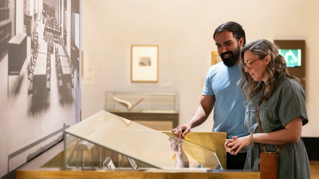 Treasures Gallery at the National Library of Australia A man and woman viewing a collection in a gallery