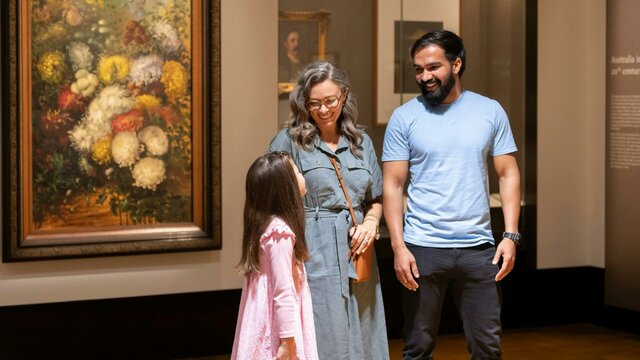 Treasures Gallery at the National Library of Australia A man, woman and young girl in the Treasures Gallery at the National Library of Australia