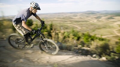 A man riding a mountain bike at Stromlo Forest Park