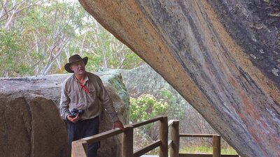 Man with a camera at Yankee Hat Aboriginal Rock Art site