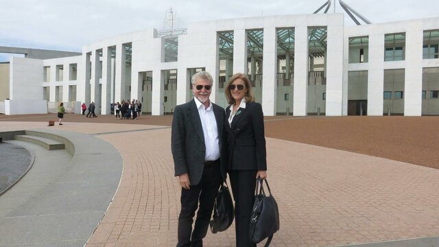 Robbie Swan and Fiona Patten. A man and a woman standing in front of the Parliament House in Canberra
