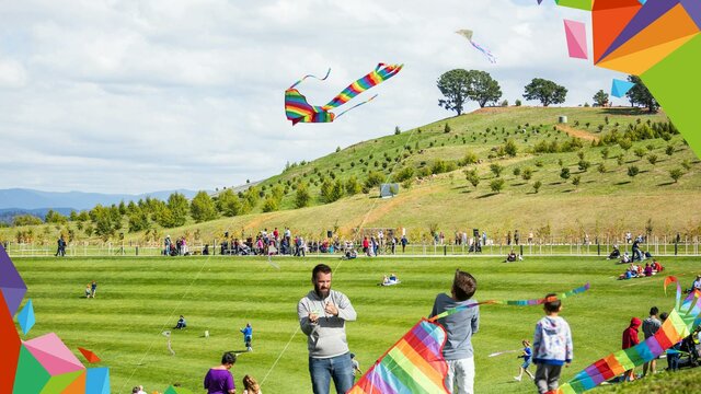Families flying kites outdoors with colourful graphic overlay
