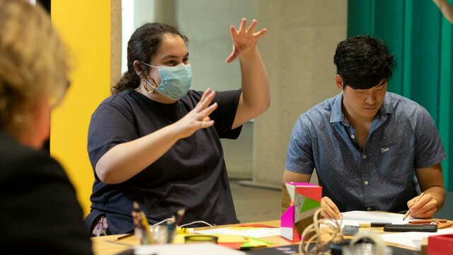 A person in a mask making art