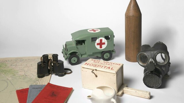 Objects including gas mask, replica ambulance, documents, map and binoculars