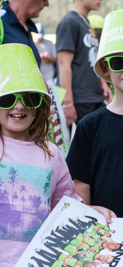 Young fans pose for a photo with Sydney Thunder giveaways at Manuka Oval