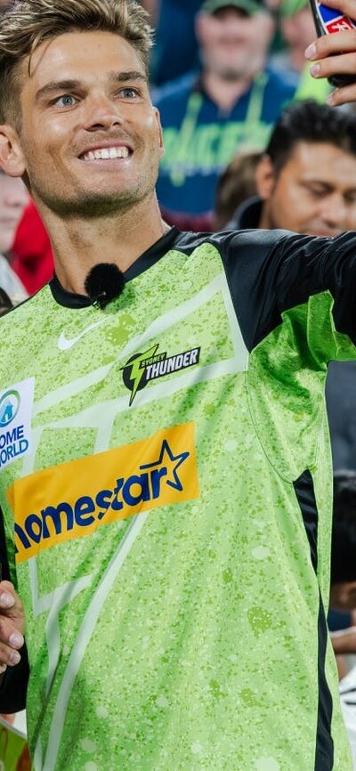 Sydney Thunder star Chris Green takes a selfie with a fan at Manuka Oval