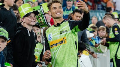 Sydney Thunder star Chris Green takes a selfie with a fan at Manuka Oval