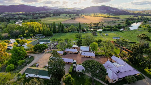 Drone image of Lanyon Homestead with buildings in foreground and brindabellas in background