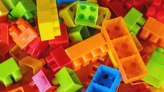A pile of rainbow coloured building blocks