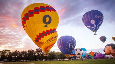 Balloons rising into the sky as dawn breaks