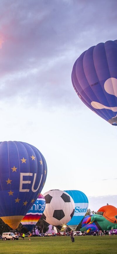 Balloons rising into the sky as dawn breaks