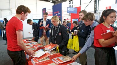 Student at desk at Canberra CareersXpo seeking information about courses and careers.