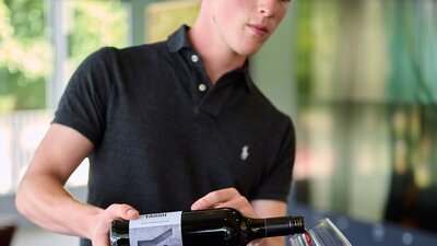 A winemaker serves wine at the Canberra Cellar Door