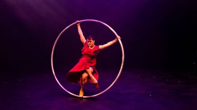 Winter Cyan, an acrobat, Spins on the  Roue Cyr, a large Metal ring bigger than an adult