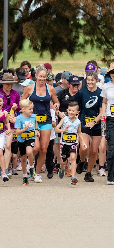 Group of people running and participating in the fun run
