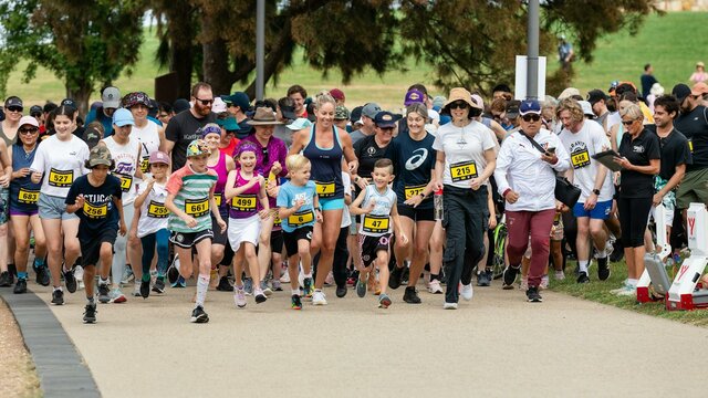 Group of people running and participating in the fun run