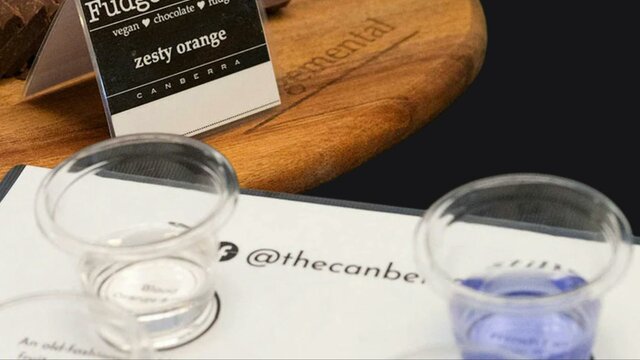 fudge on a wooden platter and tasting glasses of gin