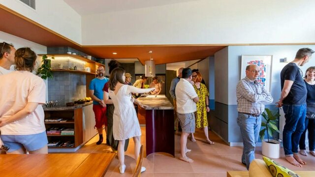 Canberra Open Homes, 2024 A group of people touring inside a home in the kitchen with bare feet