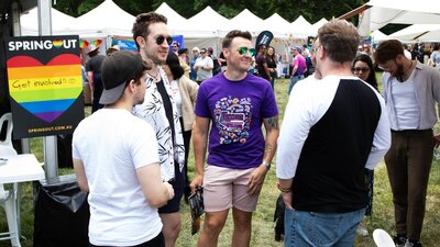 Group of friends at Fair Day with Stalls in the background