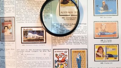 Stamp catalogue & magnifying glass, stamp collecting opens up the world to its devotees